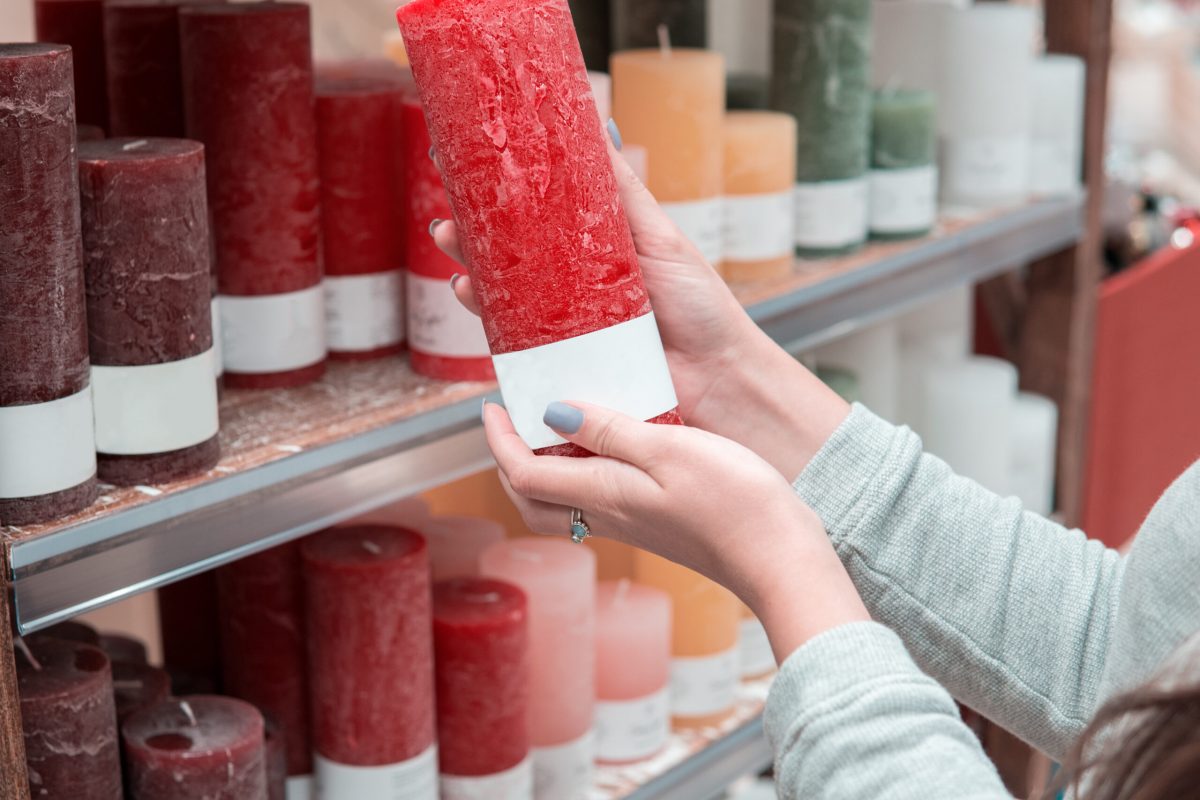 woman hands choosing festive decorative candles for Christmas or New Year Closeup view of woman hands choosing festive decorative candles for Christmas or New Year celebration